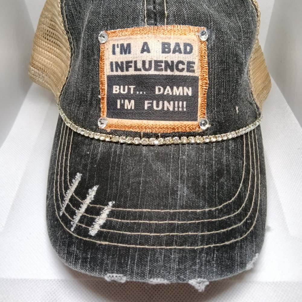 A distressed cap with a fun message "I'M A BAD INFLUENCE But.... DAMN I'M FUN!!!